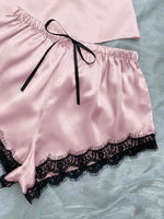 a pink and black lingerie on a bed