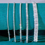 a group of diamond bracelets sitting on top of a table