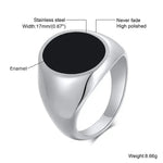 a men's ring with a black stone in the center