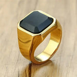 a gold ring with a black stone on it