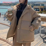 a woman standing on a pier holding a cup of coffee