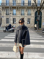 a woman is walking across a cross walk