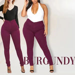 two women standing next to each other wearing purple pants