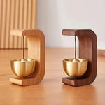 a couple of golden bowls sitting on top of a wooden table