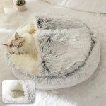 a cat curled up in a cat bed