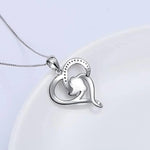 a heart shaped pendant on a white plate