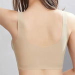 the back of a woman wearing a beige bra