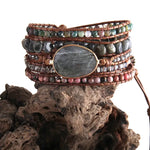 a stack of bracelets on top of a rock