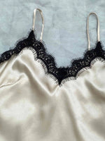 a white and black bra with black lace on it