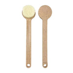 two wooden spoons and a brush on a white background