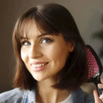 a woman holding a hair dryer in her hand