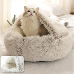 a white cat sitting in a fluffy cat bed