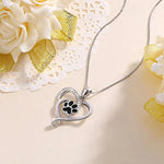 a necklace with a paw print in the shape of a heart