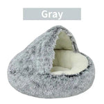 a gray cat bed with a white pillow