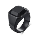 a black ring with a black stone on it