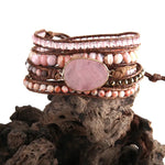 a stack of bracelets sitting on top of a rock