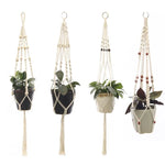 four hanging planters with plants in them