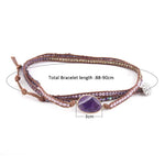 a beaded bracelet with a purple stone