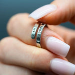 a woman's hand holding a ring with a message on it