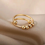 a pair of gold rings sitting on top of a white cloth