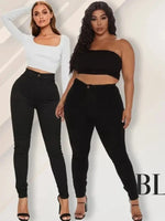 two women standing next to each other wearing black pants