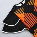 a black and orange top with a pattern on it