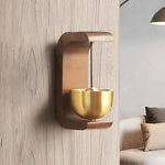 a wall mounted candle holder on a wooden wall