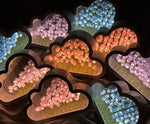 a bunch of heart shaped candies in a box