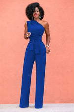 a woman in a blue jumpsuit posing for a picture