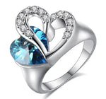 a heart shaped blue topaz ring with diamonds