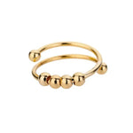 a gold ring with three balls on it