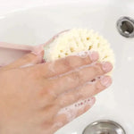 a person washing their hands with a sponge