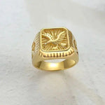 a gold ring with a bird on it