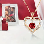 a heart shaped necklace with a photo of a man and woman in the background