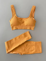 a woman's yellow sports bra top and shorts