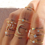 a woman's hand with five different rings on it