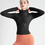 a woman in a black top and orange pants