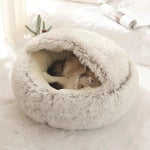 a cat curled up in a bed on a bed